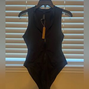 NWT Skims black zip up one piece, size M